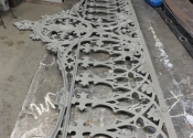 Decorative Coalbrookedale garden bench after blasting to reveal breaks in the cast iron 