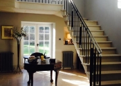 Wrought iron staircase with cast iron panels