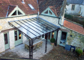 Midford Lane. Large wrought iron canopy with glass roof and lead rose detailing
