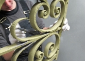 Cecilie Robinson painting the gates