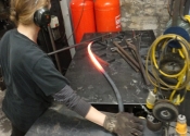 Cecilie Robinson forming cake stand bars using a jig
