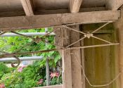 Broken wrought iron structure to underside of Georgian garden pergola