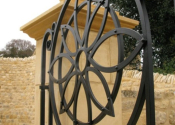 Wrought iron garden gate with flower design detail, Ebrington